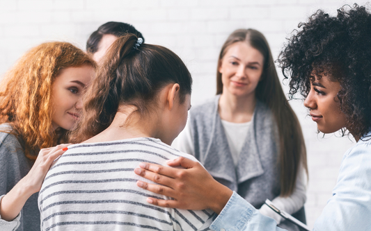 group of women helping a sad woman